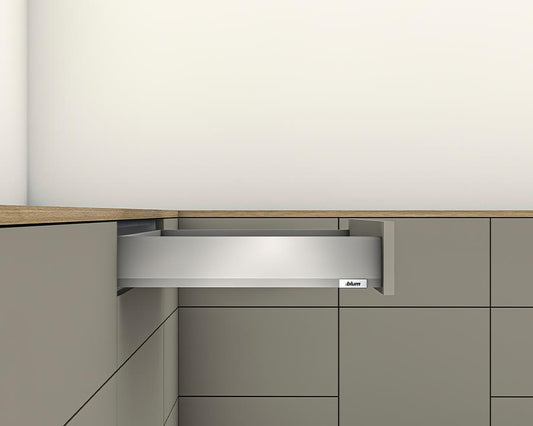 A slim indium grey drawer side design with a full extension drawer, installed in a kitchen cabinet.