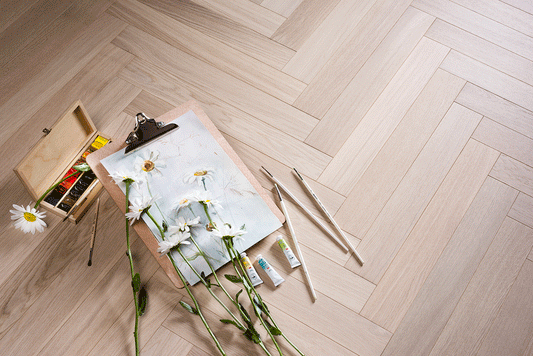 Premium Aqua White engineered oak herringbone flooring by Coswick featuring a soft white finish, European oak construction, and an elegant parquet pattern.