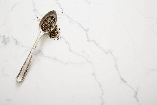 Venatino Statuario designer quartz stone with marble-look white surface and grey veining for kitchen benchtops, bathroom vanities, and laundry countertops.