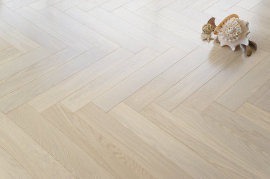 White Frost herringbone engineered timber flooring by Coswick with a light oak finish, durable multi-layer hardwood construction, and elegant parquet design for modern interiors.